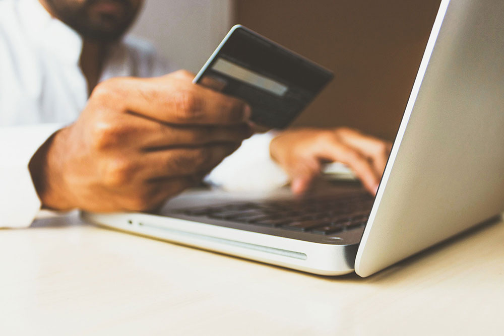 An image of a customer paying online with card.